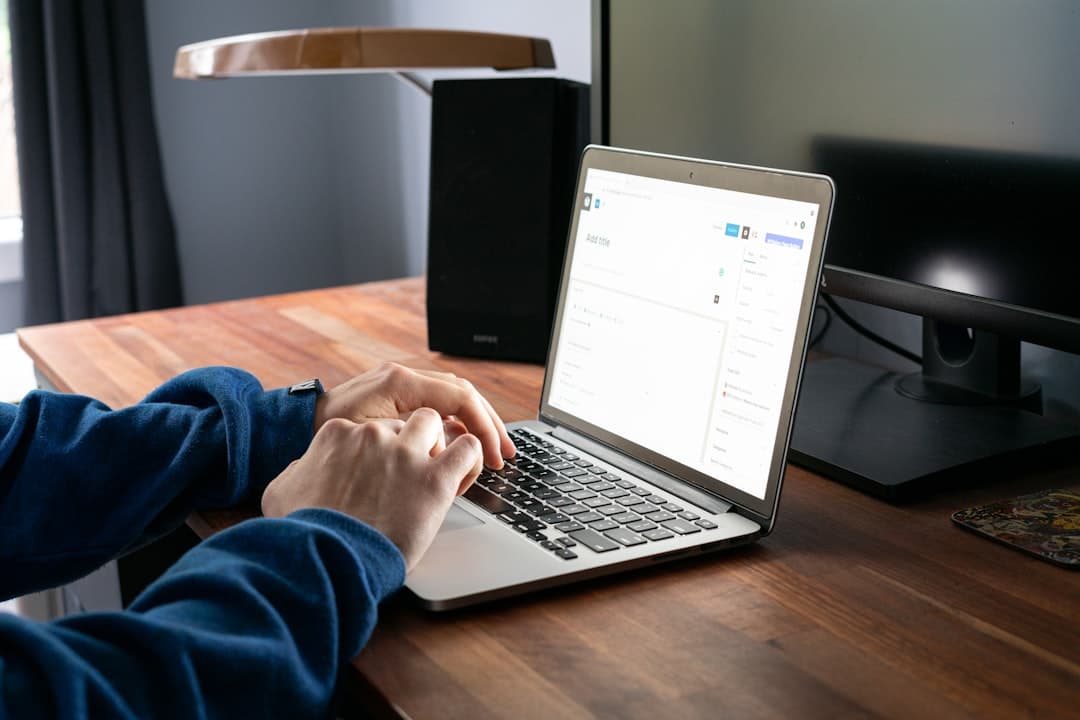 Person typing laptop office desk
